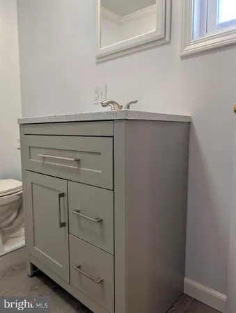 a view of room with window and wooden floor