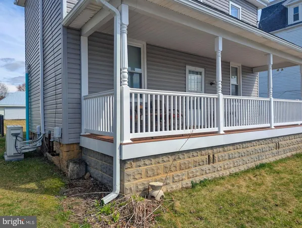 a view of a house with a small yard and wooden floor and fence