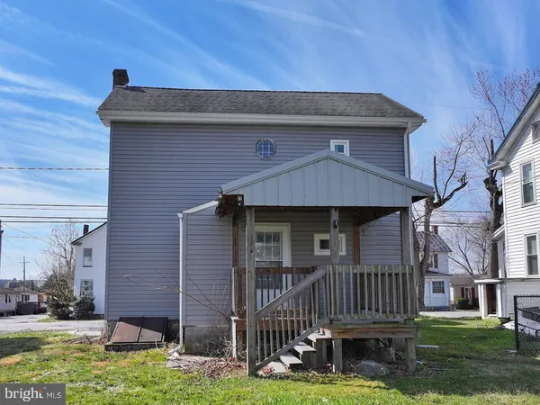 an aerial view of a house with a yard and balcony