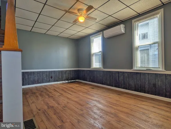 a view of an empty room with wooden floor