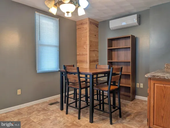 a dining room with furniture and window