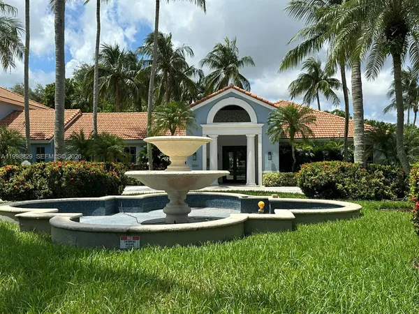 a front view of a house with swimming pool having outdoor seating