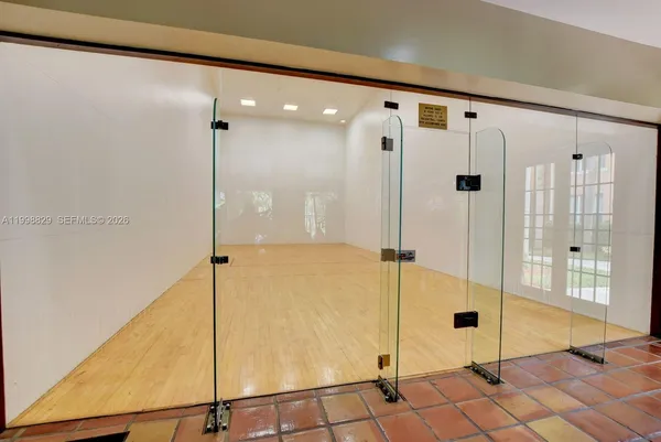 a bathroom with a glass shower door and a glass door