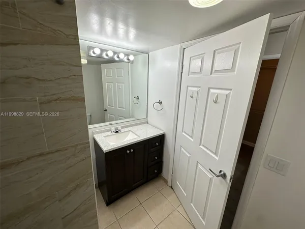 a bathroom with a sink a mirror and a shower