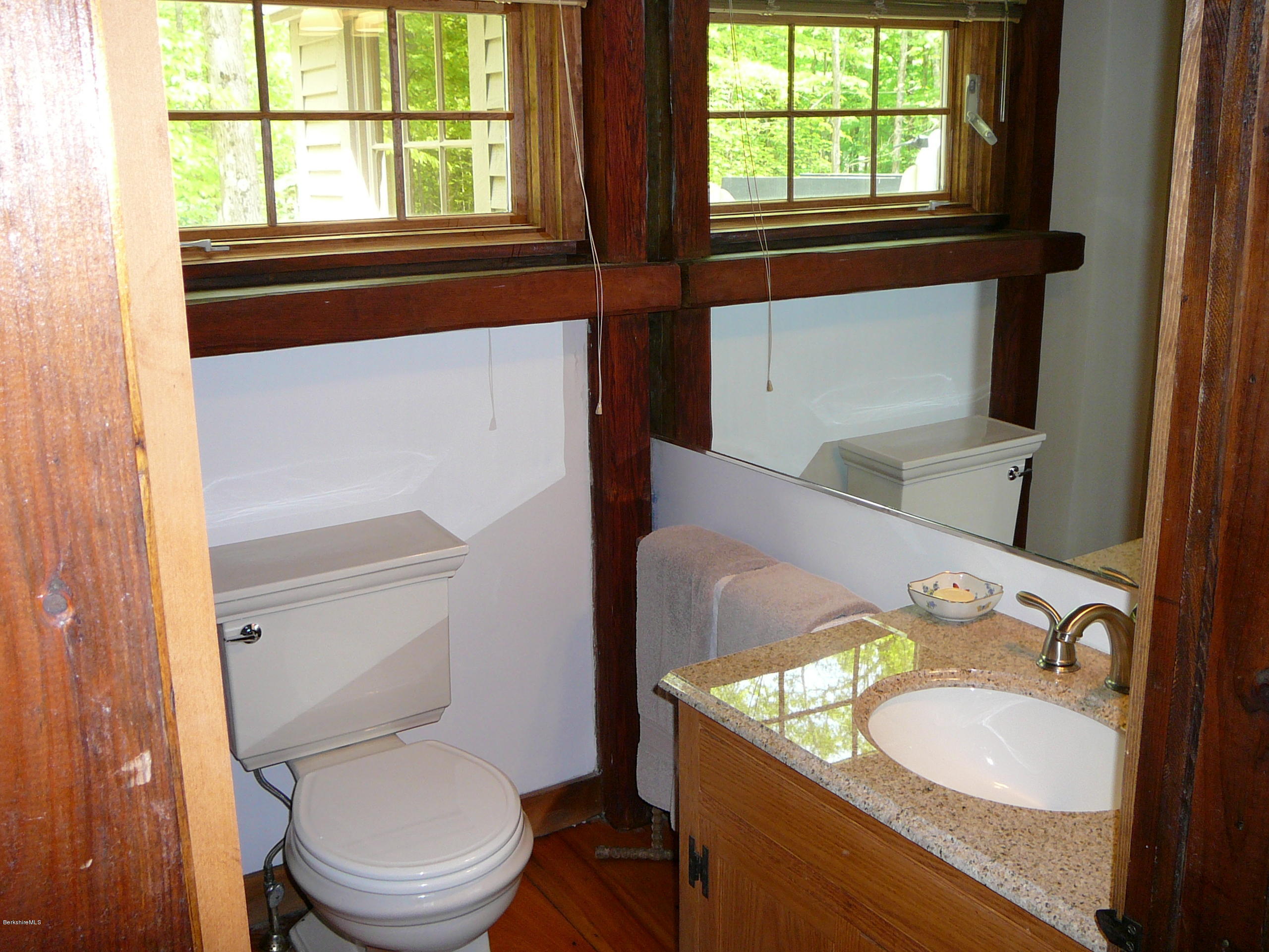 126 Tyringham Road Monterey, MA 01245 - Photo 20 of 35 a bathroom with a granite countertop toilet sink and mirror