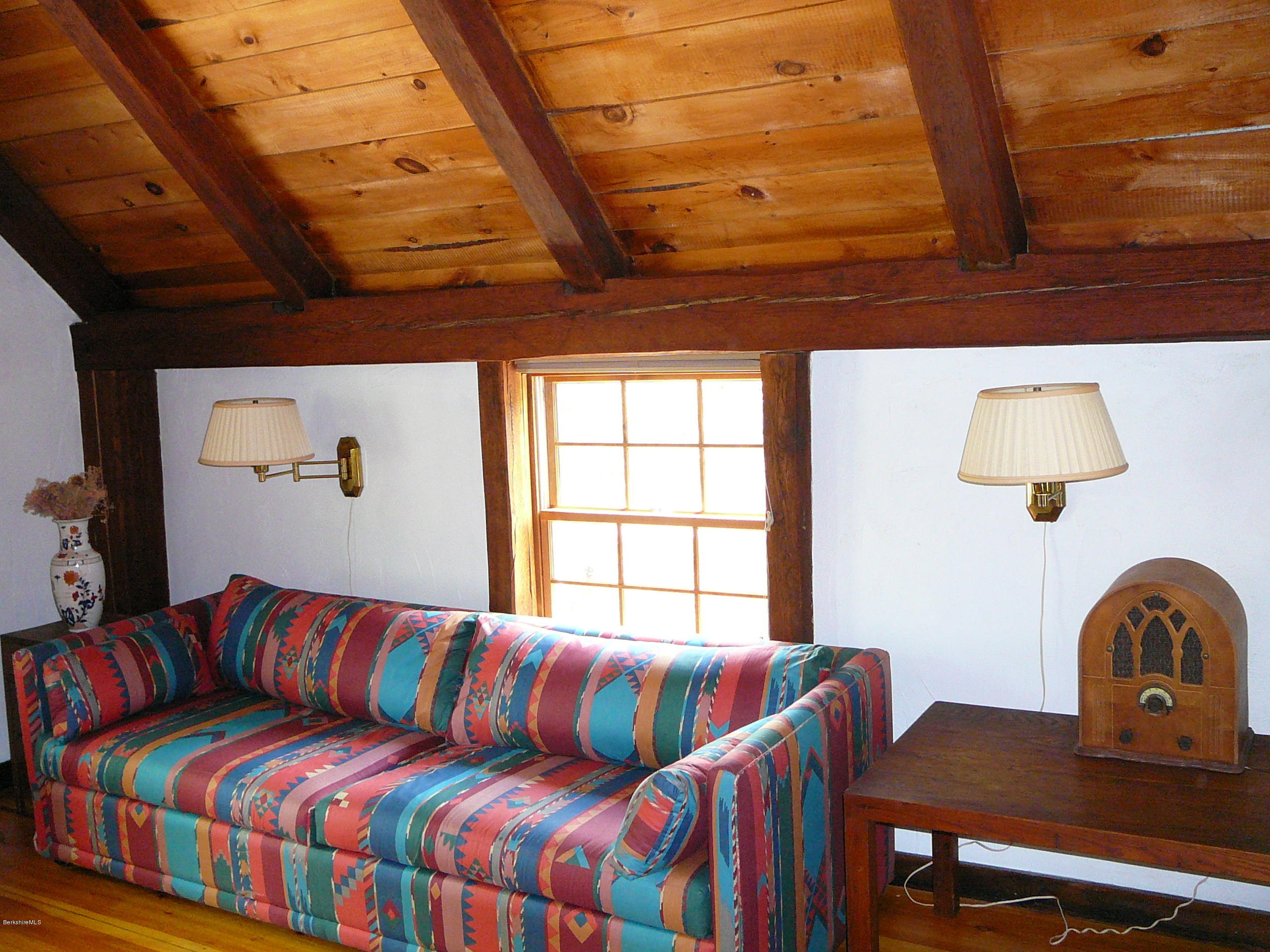 126 Tyringham Road Monterey, MA 01245 - Photo 25 of 35 a living room with a couch wooden floor and a table