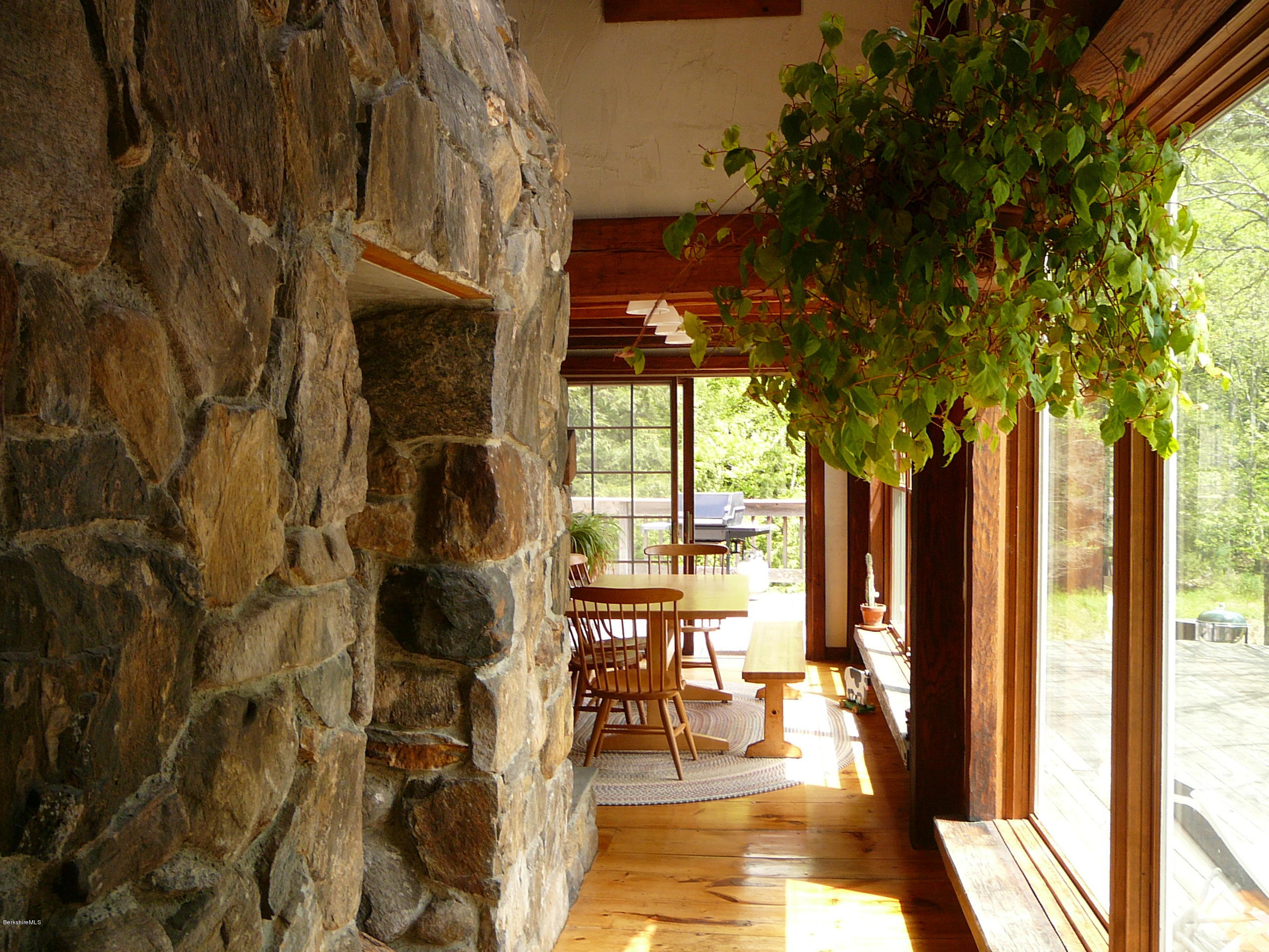 126 Tyringham Road Monterey, MA 01245 - Photo 7 of 35 a view of a patio with table and chairs and floor to ceiling window