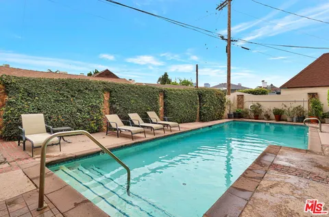 a view of a swimming pool with a lounge chairs