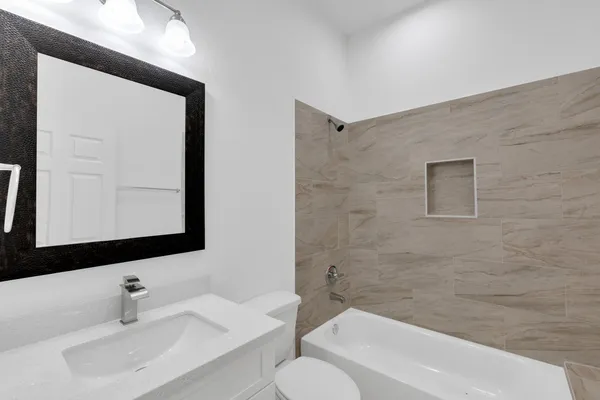 a bathroom with a sink a toilet and bathtub