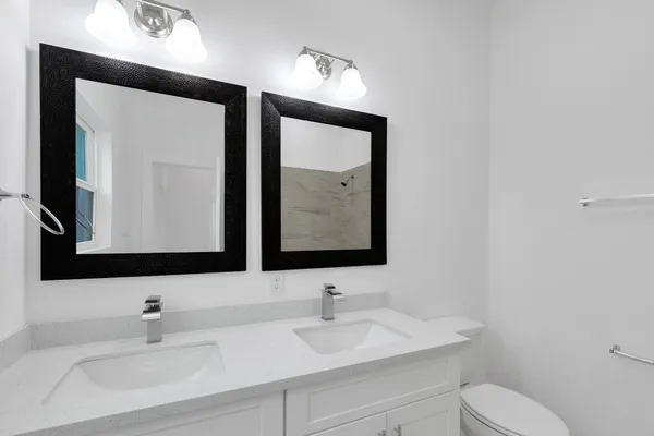 a bathroom with a toilet sink and mirror