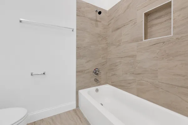 a bathroom with a bathtub and a toilet