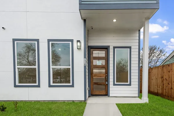 a view of front door of house with yard