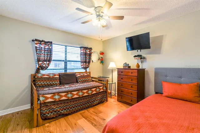 a bedroom with a bed and a flat screen tv