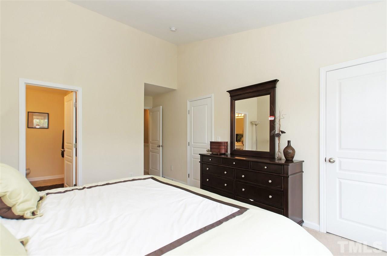 7822 Silverthread Lane Raleigh, NC 27617 - Photo 11 of 18 a bedroom with a bed and a dresser