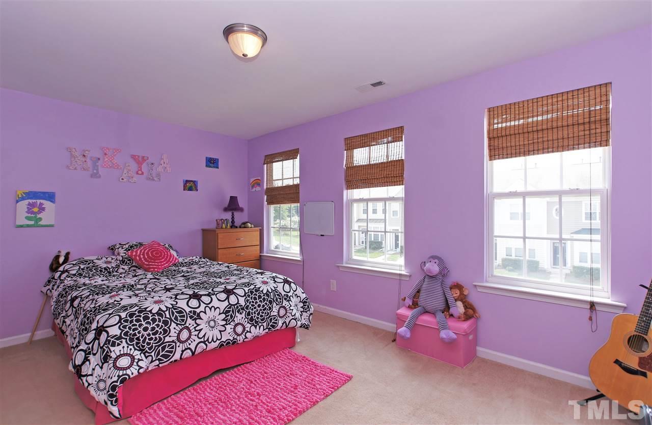 7822 Silverthread Lane Raleigh, NC 27617 - Photo 13 of 18 a bedroom with a bed dresser and a window