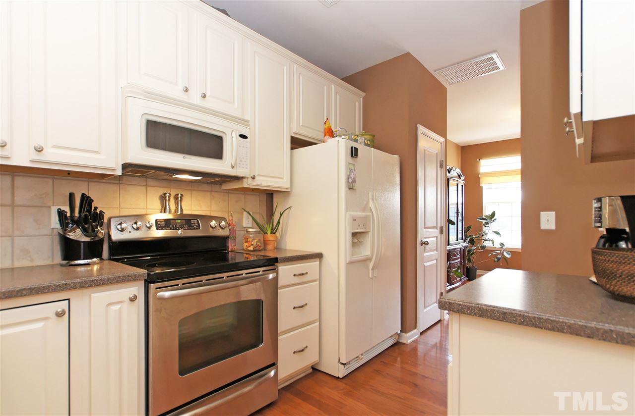 7822 Silverthread Lane Raleigh, NC 27617 - Photo 4 of 18 a kitchen with a stove and a refrigerator