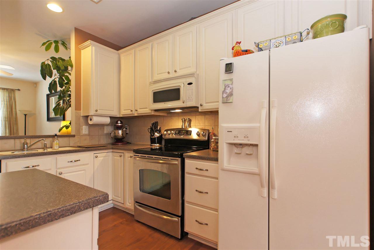 7822 Silverthread Lane Raleigh, NC 27617 - Photo 5 of 18 a kitchen with a sink a stove a refrigerator and cabinets