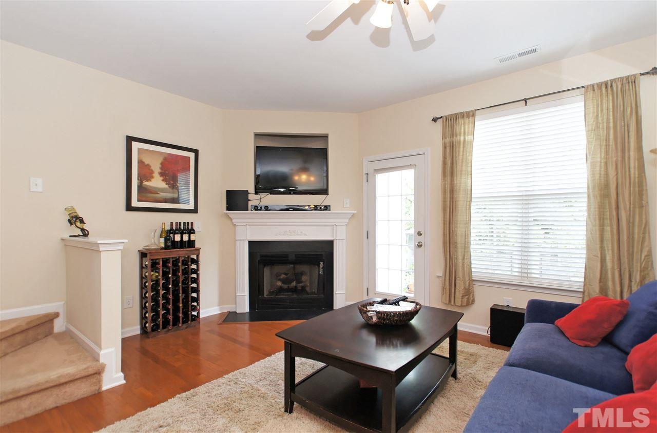 7822 Silverthread Lane Raleigh, NC 27617 - Photo 8 of 18 a living room with furniture a rug and a fireplace