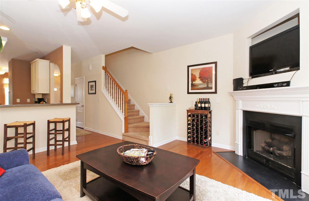 7822 Silverthread Lane Raleigh, NC 27617 - Photo 9 of 18 a living room with furniture a flat screen tv and a fireplace