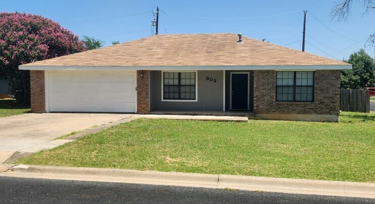 302 Burning Tree Drive Georgetown, TX 78628 - Photo 1 of 30 a front view of a house with a garden