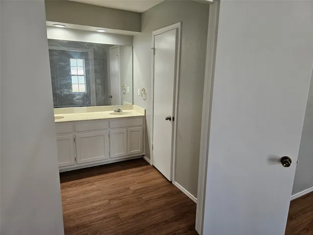 a bathroom with a sink mirror and a bathtub