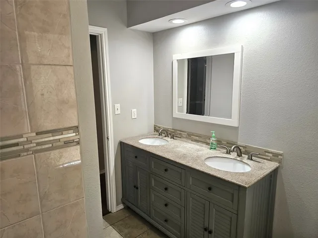 a bathroom with a sink double vanity and a mirror