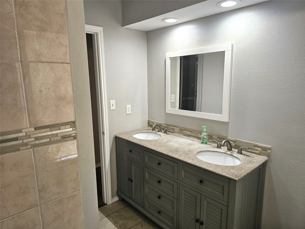 302 Burning Tree Drive Georgetown, TX 78628 - Photo 20 of 30 a bathroom with a sink double vanity and a mirror