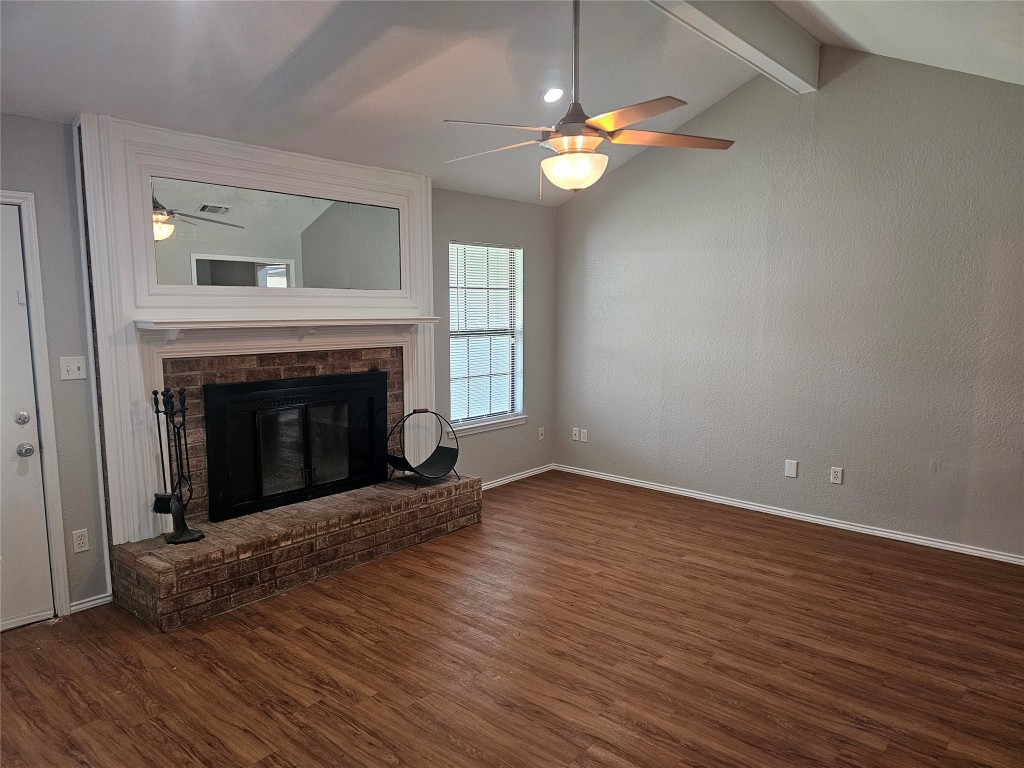 302 Burning Tree Drive Georgetown, TX 78628 - Photo 5 of 30 a view of an empty room with wooden floor fireplace and a window