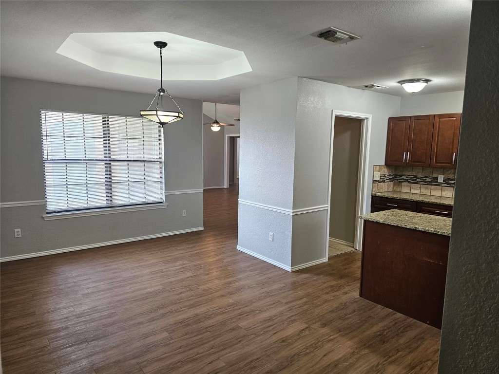 302 Burning Tree Drive Georgetown, TX 78628 - Photo 6 of 30 an empty room with wooden floor kitchen view and windows
