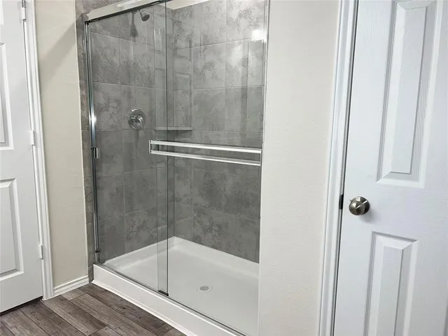 a bathroom with a glass shower door