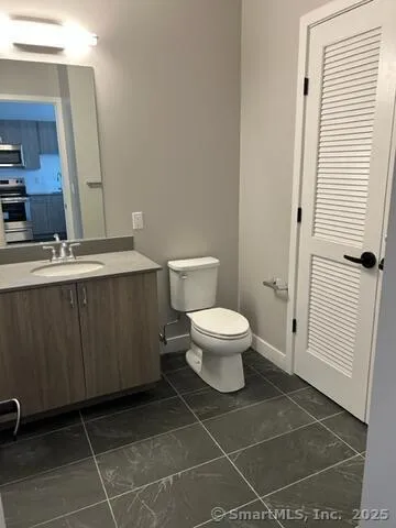 a bathroom with a toilet a sink and a mirror