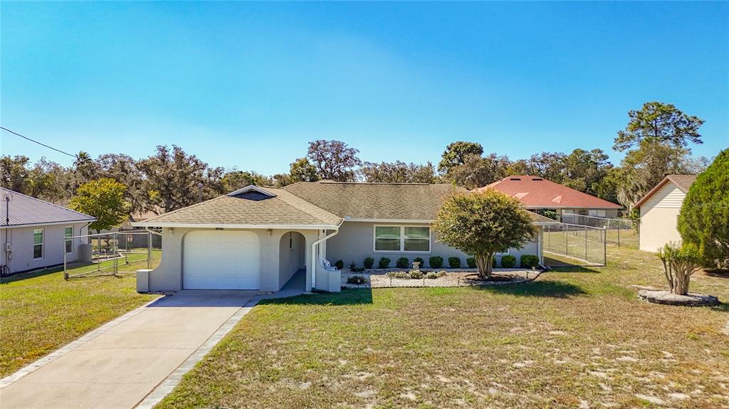 12224 Foothill Street Spring Hill, FL 34609 - Photo 1 of 1 a view of a house with swimming pool and sitting area