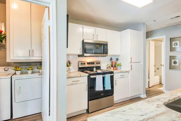 a kitchen with stainless steel appliances a stove microwave and a refrigerator