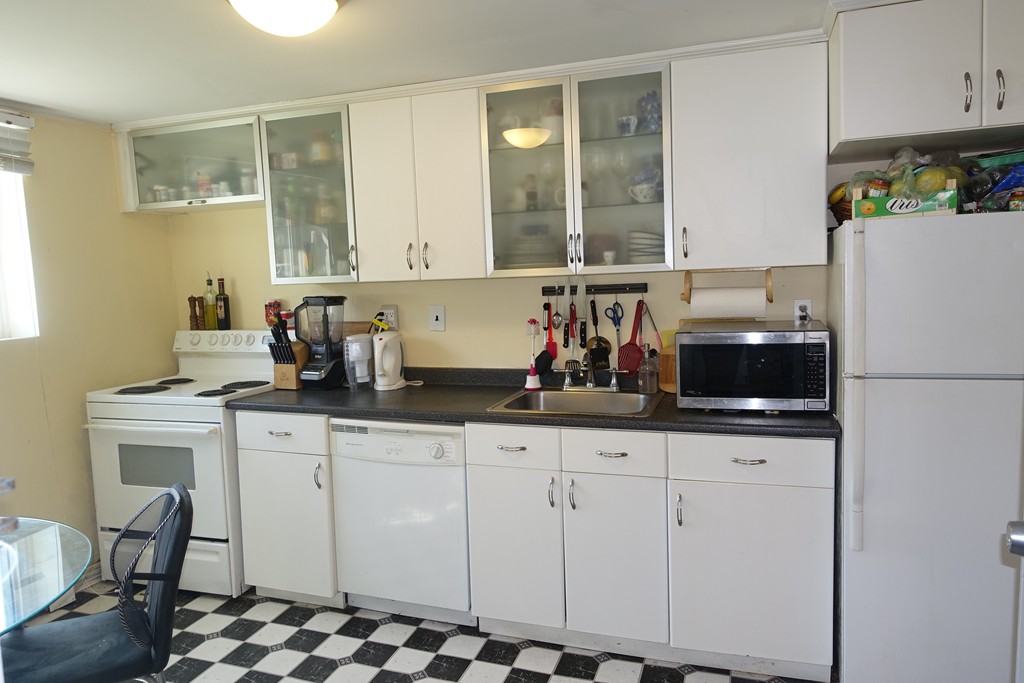 58 Bryon Road, Unit 2 Boston, MA 02467 - Photo 3 of 6 a kitchen with granite countertop a sink cabinets and appliances
