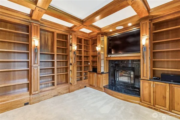 a view of an empty room with a fireplace and a window