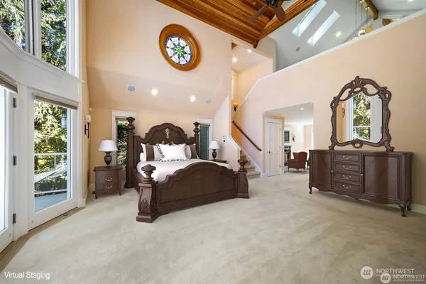 a bedroom with a bed and a chandelier