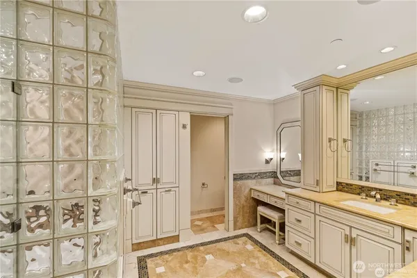 a spacious bathroom with a double vanity sink a mirror and a shower