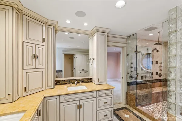 a spacious bathroom with a shower sink and mirror