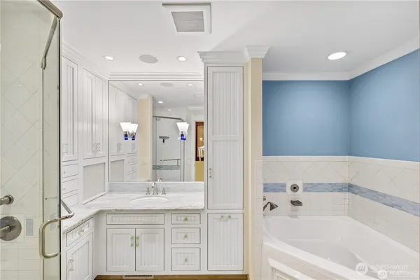 a bathroom with a granite countertop sink a mirror a shower and a bathtub