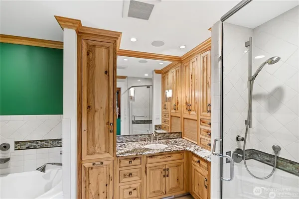 a bathroom with a granite countertop sink and a mirror