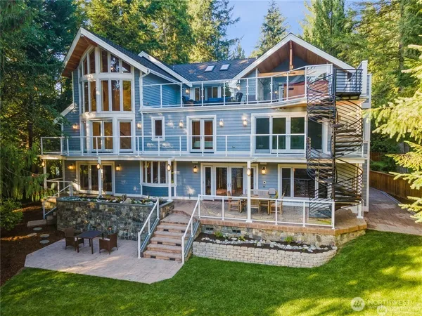 a front view of a house with a yard table and chairs