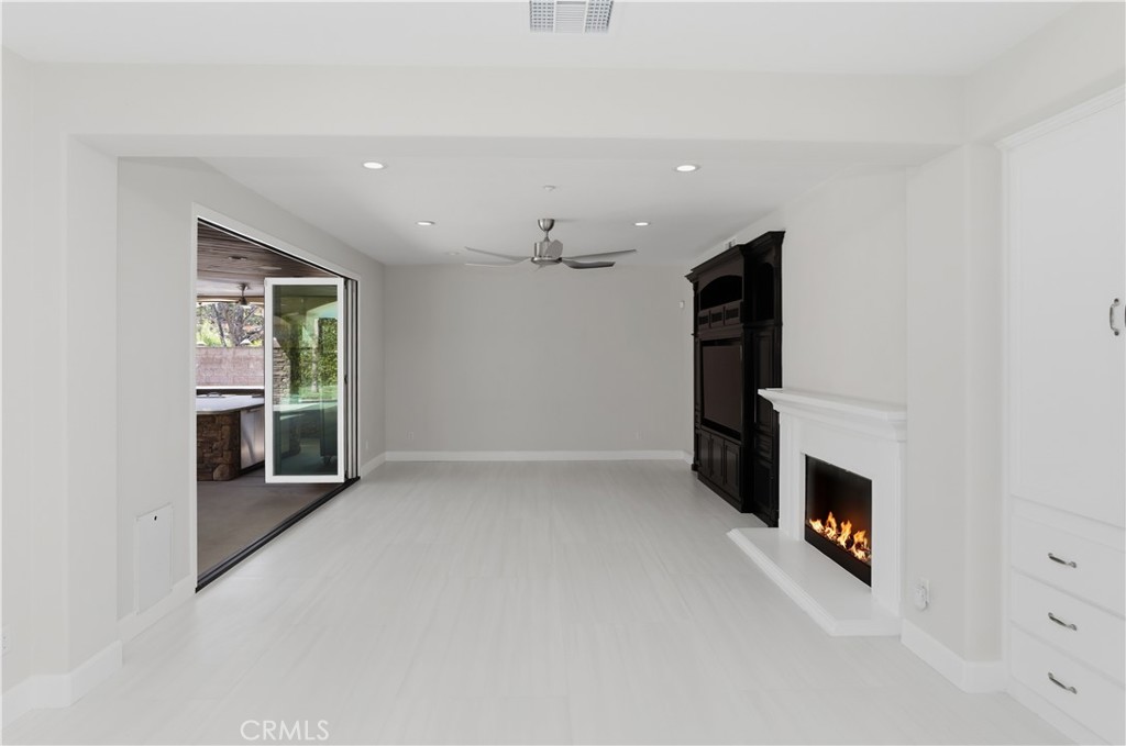 8075 Terraza Court Riverside, CA 92508 - Photo 14 of 75 an empty room with fireplace and windows