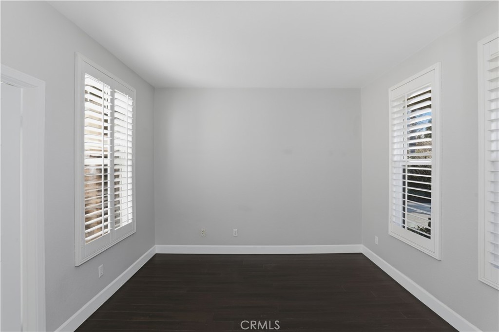 8075 Terraza Court Riverside, CA 92508 - Photo 15 of 75 a view of an empty room with wooden floor and a window