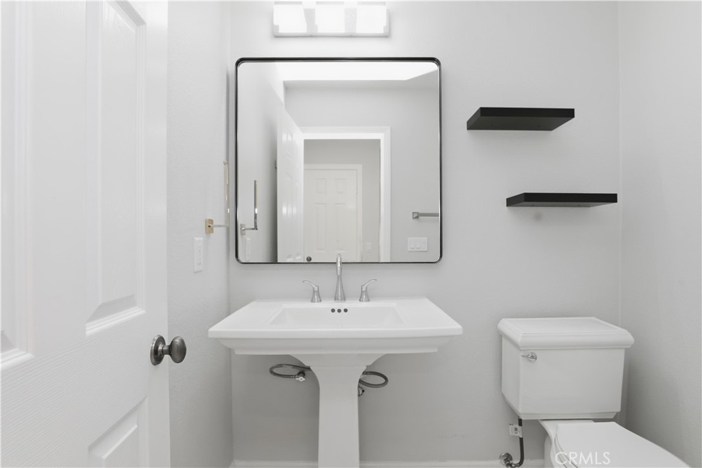 8075 Terraza Court Riverside, CA 92508 - Photo 17 of 75 a bathroom with a toilet sink and mirror