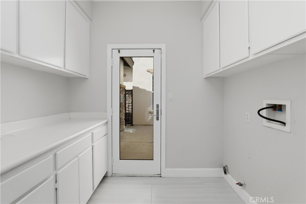8075 Terraza Court Riverside, CA 92508 - Photo 19 of 75 a utility room with cabinets