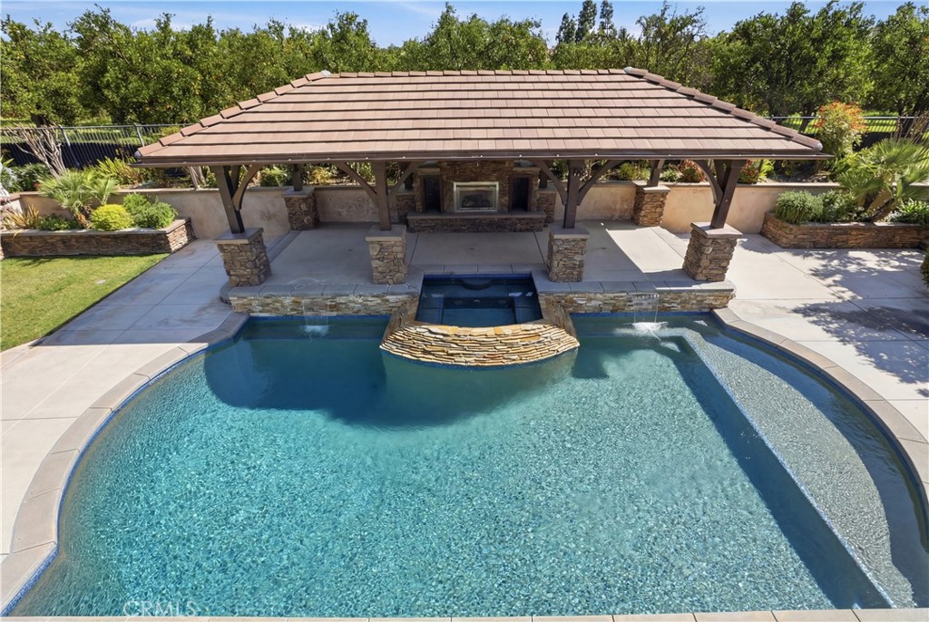 8075 Terraza Court Riverside, CA 92508 - Photo 26 of 75 a view of a backyard with table and chairs under an umbrella