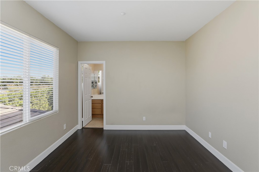 8075 Terraza Court Riverside, CA 92508 - Photo 27 of 75 an empty room with wooden floor and windows
