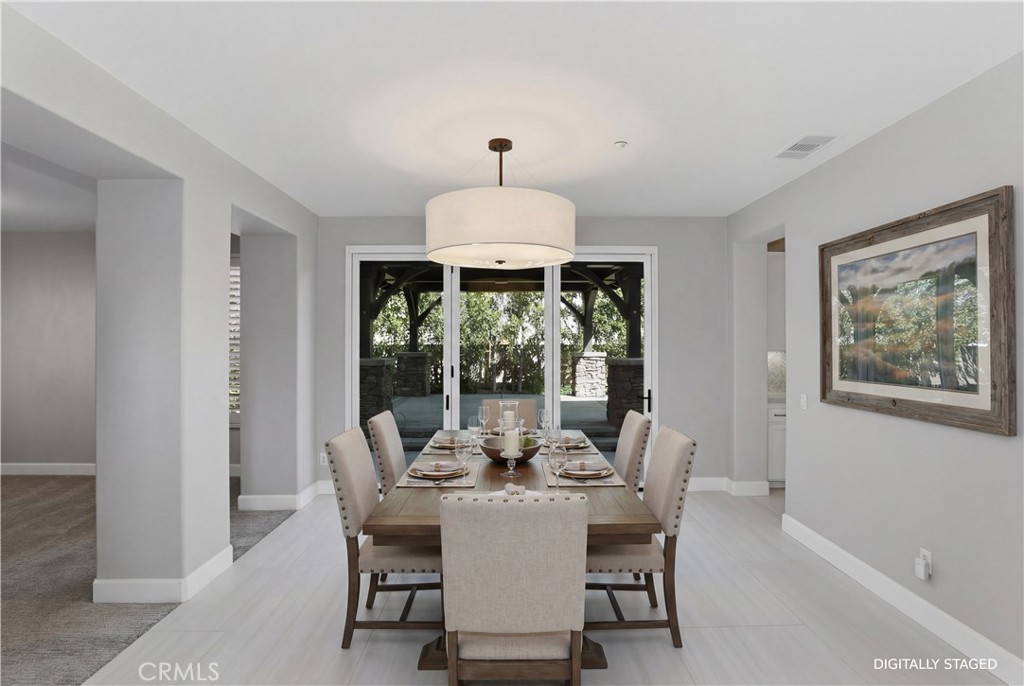 8075 Terraza Court Riverside, CA 92508 - Photo 8 of 75 a dining room with furniture a chandelier and a rug