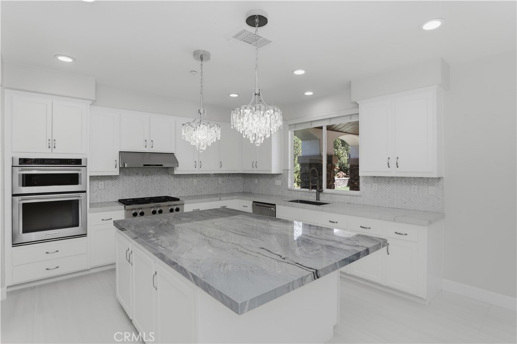 8075 Terraza Court Riverside, CA 92508 - Photo 10 of 75 a kitchen with granite countertop a sink a stove and oven