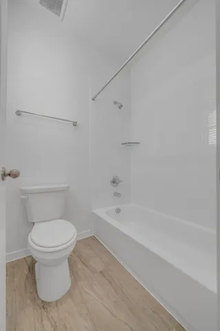 a bathroom with a toilet and a bathtub